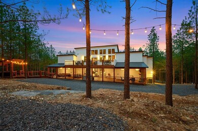 Back house at dusk with a balcony