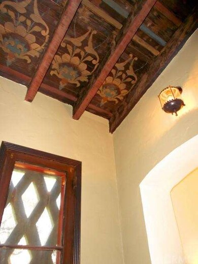 Original hand painted wood ceiling in entryway. 