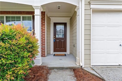 Entrance to property with an attached garage and brick front