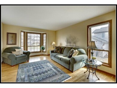 Living room with bay window and hardwood floors