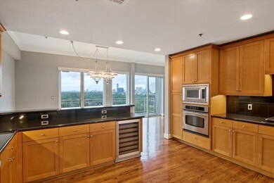 This kitchen boasts a sleek beverage bar, built-in
