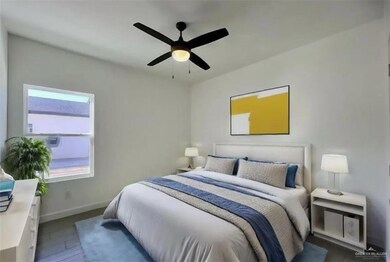 Bedroom featuring baseboards, ceiling fan, and wood finished floors