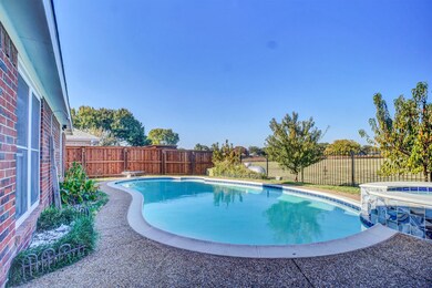 View of swimming pool with a fenced backyard, a pool with connected hot tub, a patio, and a diving board