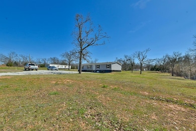 View of grassy yard with driveway
