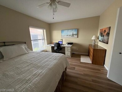 Bedroom with ceiling fan, baseboards, and wood fin