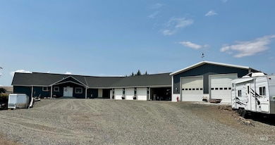 Single family home with a full basement, featuring a 3 car garage, large carport, shop & barn on 2.32 acres