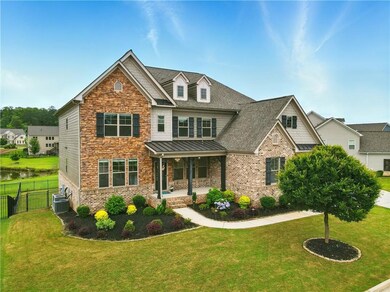 Craftsman-style house with a porch, a standing seam roof, a shingled roof, central AC, and stone siding