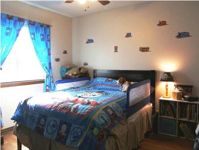 Bedroom 2 on the main floor also features a fan wi