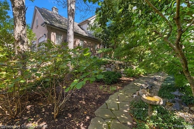 View of side of property featuring brick siding and a chimney
