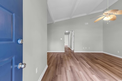 Empty room featuring a ceiling fan and wood finished floors