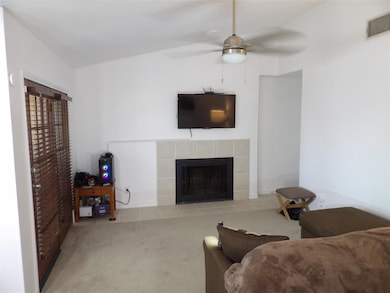 Living area with a tile wood burning fireplace, ce