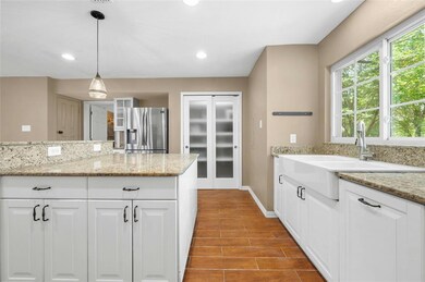 Kitchen featuring stainless steel fridge with ice