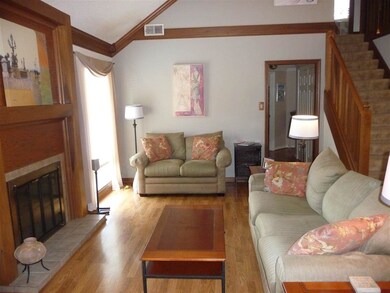 Open great room with gas fireplace and hardwood fl
