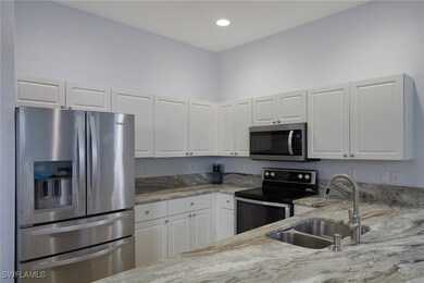 Kitchen with stainless steel appliances, a sink, l