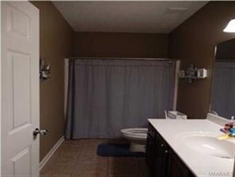 This spacious second bath can easily accommodate g