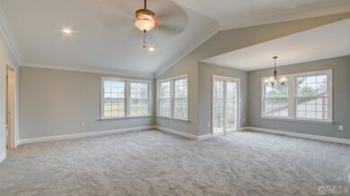 Huge living room overlooking the golf course; natural light pours in.