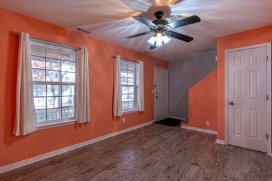 Entrance foyer with dark wood finished floors and ceiling fan