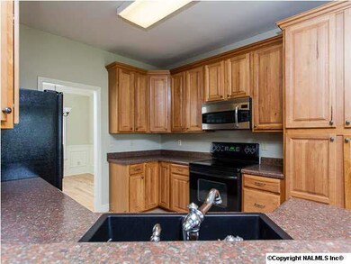 CABINETRY OFFERS PLENTY OF CABINET AND COUNTER STORAGE, PLUS A FULL LENGTH STACKED PANTRY SPACE.