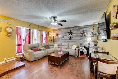 Living area featuring wood finished floors, an acc