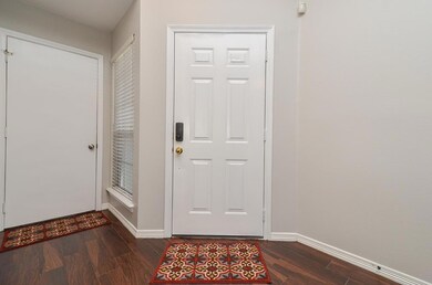 Wood-like tile flooring from entry door throughout living & dining areas.