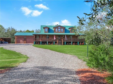 Log home with a porch, a garage, and a front lawn