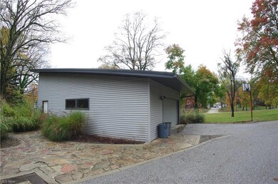 Detached 2 car garage with workshop and rear door.