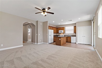 Kitchen featuring white appliances, open floor pla