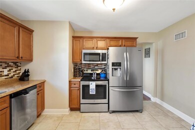 Beautiful Ceramic Tile Floor and Stainless Elec Stove and Microwave.