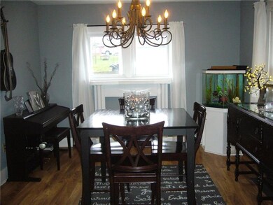 Formal dining room with laminate flooring and plen