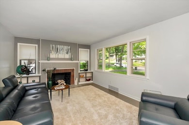 Living area with healthy amount of natural light and a fireplace