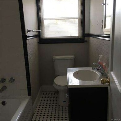 Downstairs bath with tub/shower, new toilet and ti