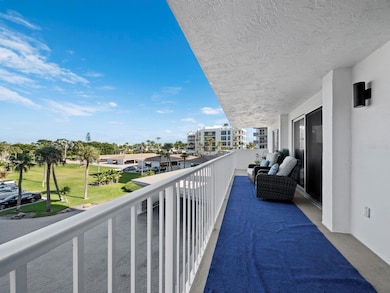 The balcony off the living room, 2nd bedroom and primary bedroom stretches the whole length of the condo with beautiful garden and golf course views.