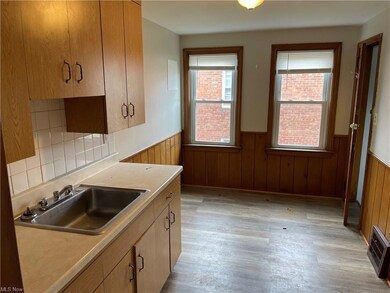 Kitchen with backsplash, light countertops, and li