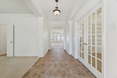 Upon entering, this elongated entryway with tiled floor, offers the home office/study to the right through the French doors and formal dining to the left. Entry: (16x6)