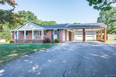 Ranch-style house with a carport, a front yard, an