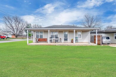 View of front of property with covered porch and a