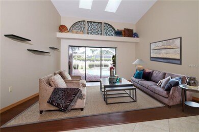 The living room features wood floors and sliding d