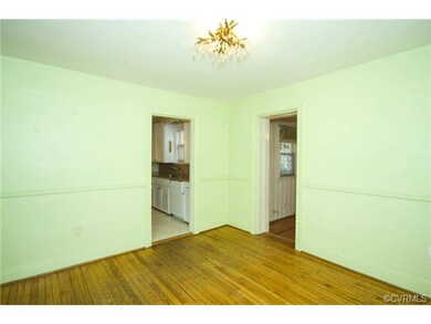 The dining room has hardwood floor, chair rail and