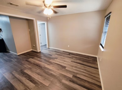 Unfurnished bedroom with a ceiling fan, visible ve