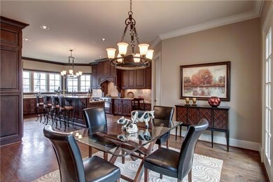 Open entertainment chef’s kitchen with eat-in dining and easy access to the entertainment deck, butlers pantry and family room.  Custom cabinets, granite counters, serve over bar- premium appliances. 