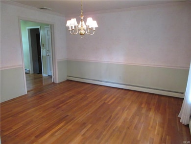 Dining room with crown molding, chair rail and har