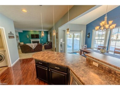 THE KITCHEN IS OPEN TO BOTH THE DINING AREA AND TH