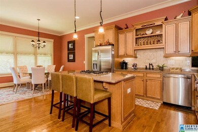 This kitchen is perfect for the cook of the home, and as a family gathering spot. Granite countertops, tile backsplash, stainless appliances including a gas cooktop. Working island /breakfast bar plus large eating space. Custom cabinets too!