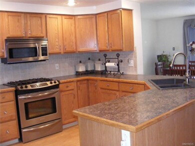 Efficient updated kitchen with ceramic backsplash.