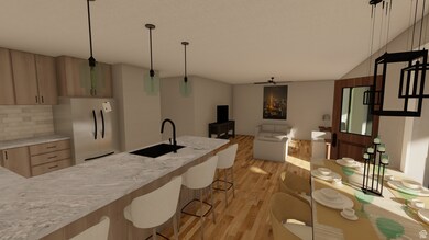 Kitchen featuring light wood finished floors, freestanding refrigerator, light stone counters, tasteful backsplash, and open floor plan