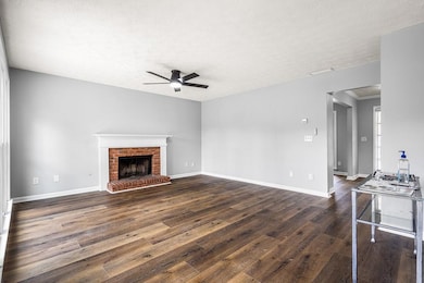 Unfurnished living room featuring dark wood finish