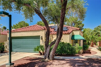 Mediterranean / spanish-style house featuring a ga