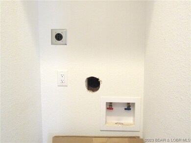 Utility room with washer/dryer hook ups for a stac