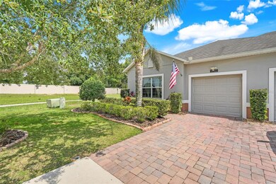 Charming street view with a spacious driveway leading to an attached garage—ample parking and great curb appeal.