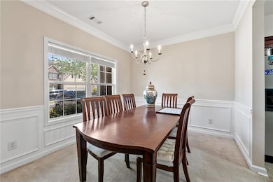 Dining space featuring visible vents, a chandelier